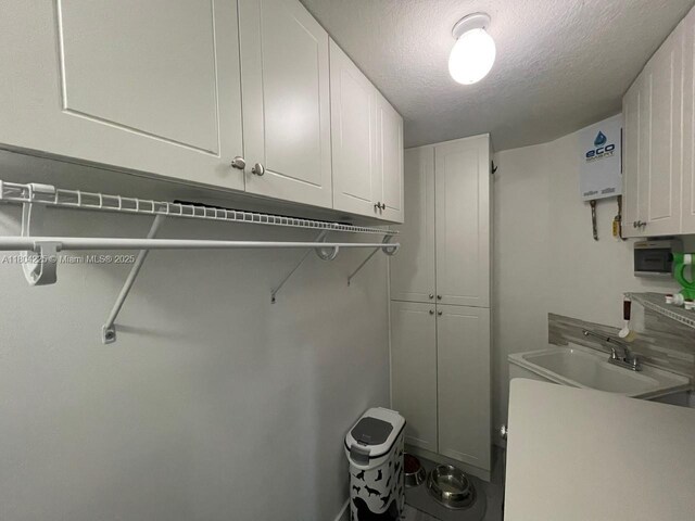 17201 SW 143rd Ct, Miami, FL 33177 - laundry area with a sink and a textured ceiling