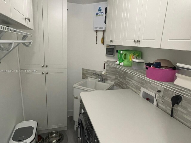 17201 SW 143rd Ct, Miami, FL 33177 - laundry area featuring cabinet space, hookup for a washing machine, and tankless water heater