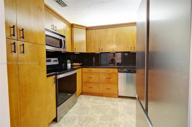 928 W 31st St, Hialeah, FL 33012 - kitchen featuring appliances with stainless steel finishes, dark countertops, backsplash, and light tile patterned floors