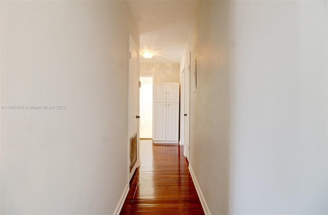928 W 31st St, Hialeah, FL 33012 - hallway featuring dark wood finished floors and baseboards