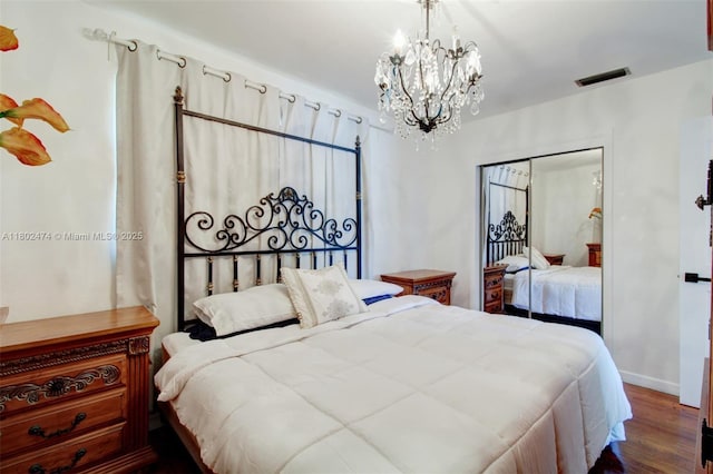 928 W 31st St, Hialeah, FL 33012 - bedroom featuring a chandelier, dark wood-style floors, and baseboards