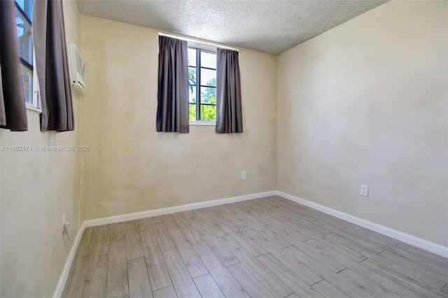 928 W 31st St, Hialeah, FL 33012 - empty room featuring wood finished floors, a textured ceiling, and baseboards