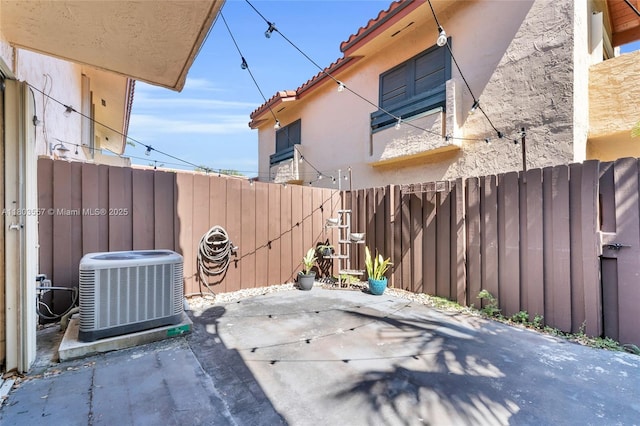 view of patio featuring central AC and fence