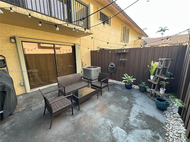 view of patio / terrace featuring central AC and fence