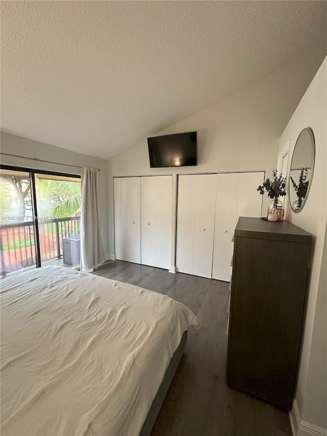 bedroom featuring access to exterior, vaulted ceiling, multiple closets, a textured ceiling, and dark wood-type flooring