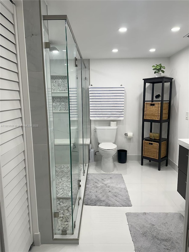 bathroom featuring a shower stall, toilet, recessed lighting, vanity, and baseboards