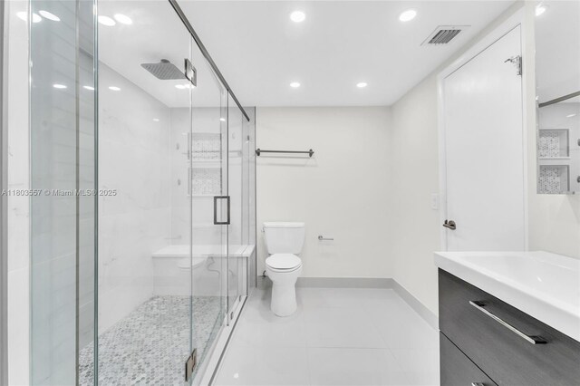 bathroom with toilet, a stall shower, baseboards, vanity, and recessed lighting