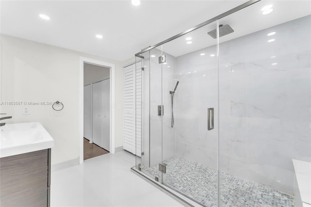 bathroom with recessed lighting, a stall shower, vanity, tile patterned flooring, and baseboards