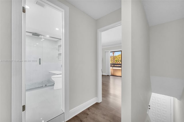 hall with wood finished floors and baseboards