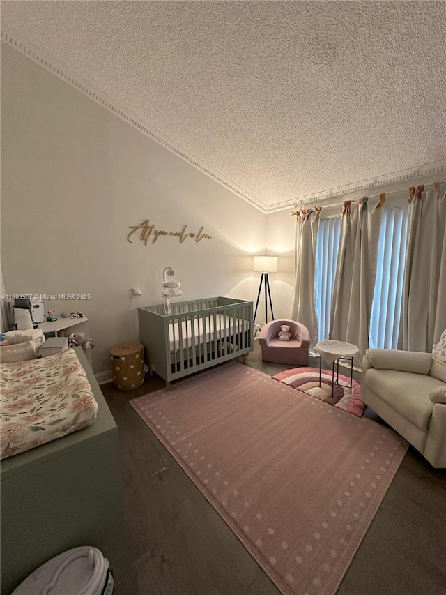 bedroom featuring a textured ceiling and ornamental molding