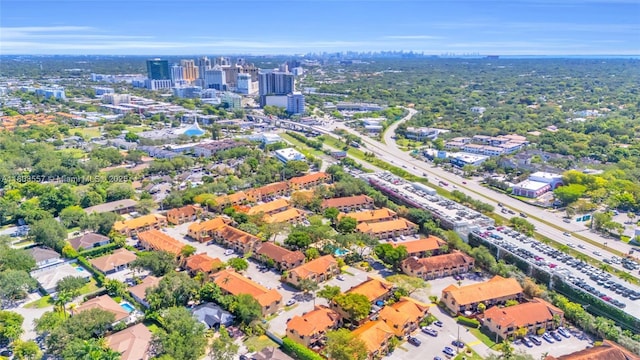 aerial view of property and surrounding area with nearby urban area