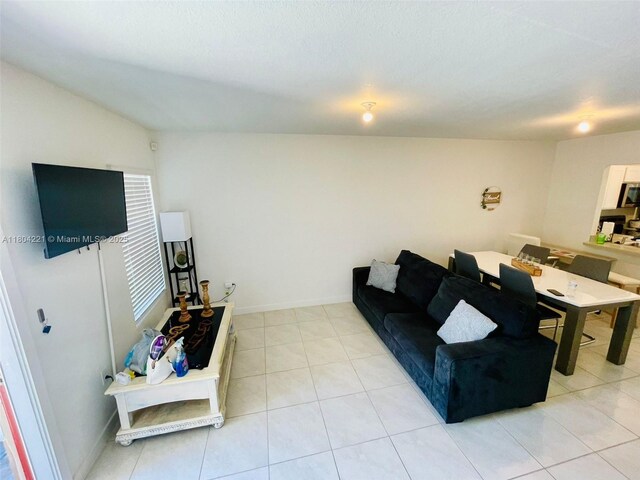 448 NE 4th St, Florida City, FL 33034 - living room featuring light tile patterned floors and baseboards