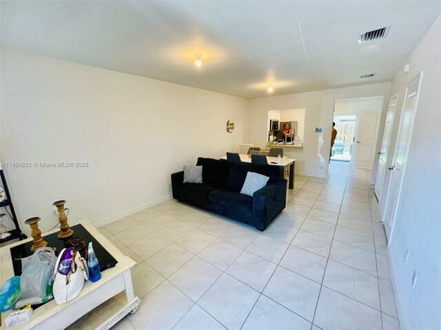 448 NE 4th St, Florida City, FL 33034 - living area with light tile patterned flooring and baseboards