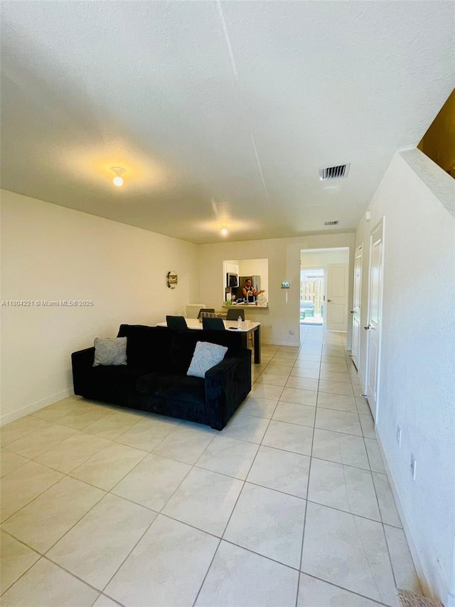 448 NE 4th St, Florida City, FL 33034 - living area featuring baseboards and light tile patterned floors
