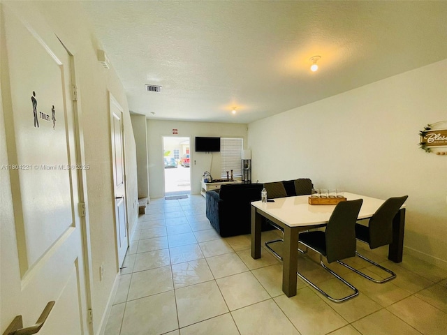 448 NE 4th St, Florida City, FL 33034 - dining space featuring light tile patterned floors, baseboards, and a textured ceiling