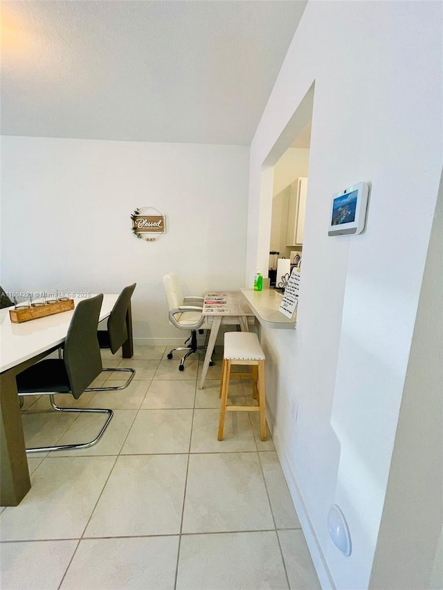 448 NE 4th St, Florida City, FL 33034 - dining space with light tile patterned floors, an office area, and baseboards