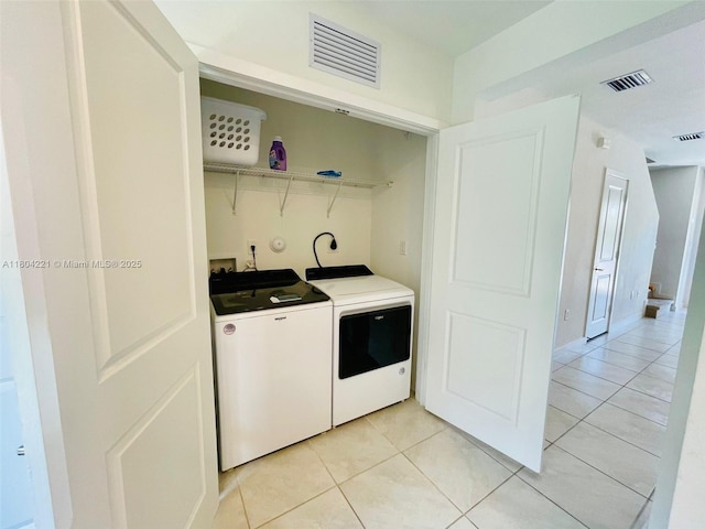 448 NE 4th St, Florida City, FL 33034 - clothes washing area with washer and dryer and light tile patterned flooring