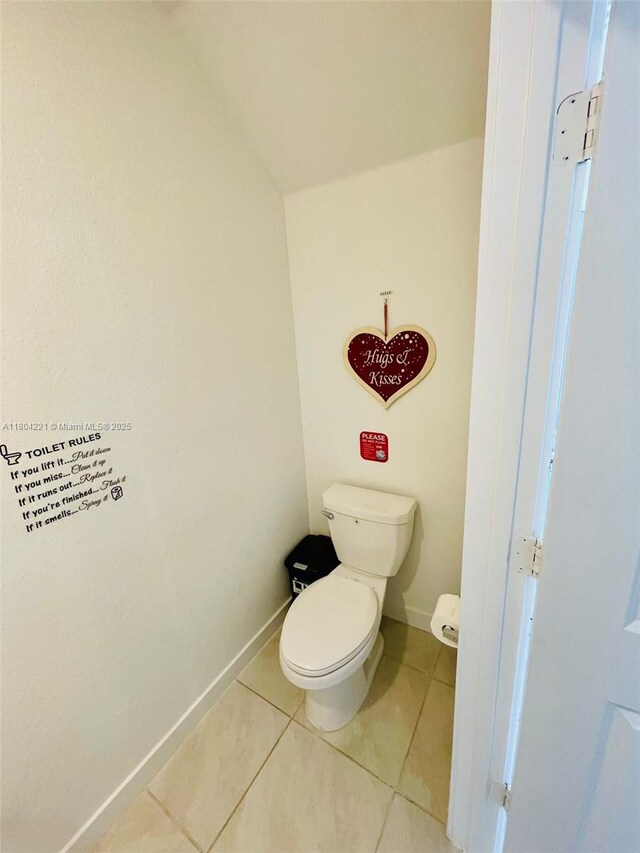 448 NE 4th St, Florida City, FL 33034 - bathroom with tile patterned flooring, baseboards, and toilet