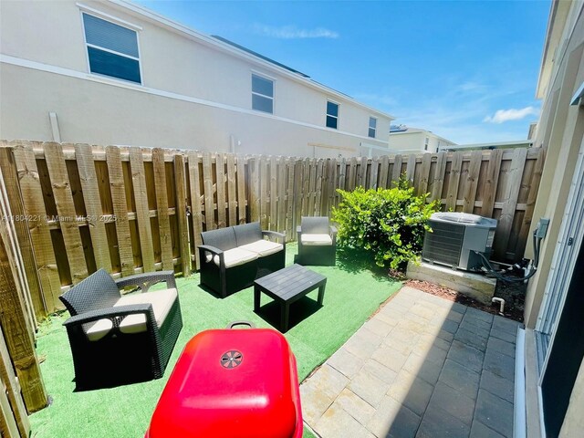 448 NE 4th St, Florida City, FL 33034 - view of patio featuring fence, cooling unit, and outdoor lounge area