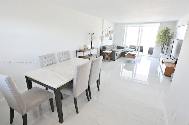 947 Lenox Ave Unit 504, Miami Beach, FL 33139 - dining space featuring light marble finish floors and floor to ceiling windows