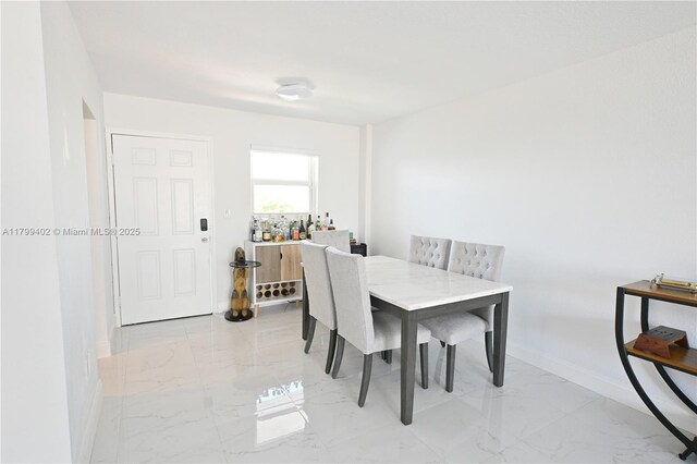 947 Lenox Ave Unit 504, Miami Beach, FL 33139 - dining area with light marble finish floors and baseboards