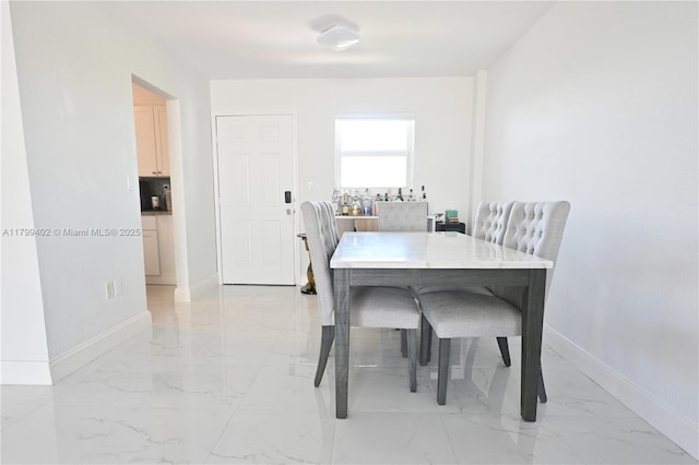 947 Lenox Ave Unit 504, Miami Beach, FL 33139 - dining area featuring light marble finish flooring and baseboards
