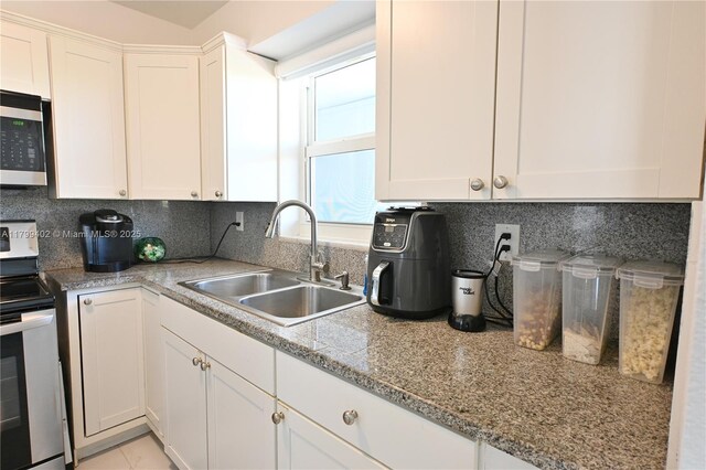 947 Lenox Ave Unit 504, Miami Beach, FL 33139 - kitchen with a sink, appliances with stainless steel finishes, and white cabinets