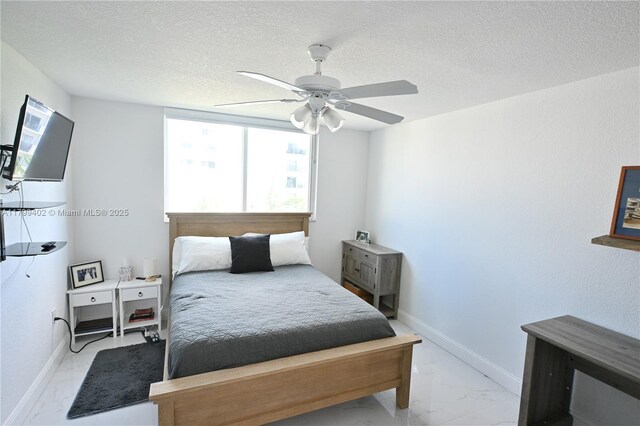 947 Lenox Ave Unit 504, Miami Beach, FL 33139 - bedroom featuring marble look tiles, a textured ceiling, a ceiling fan, and baseboards