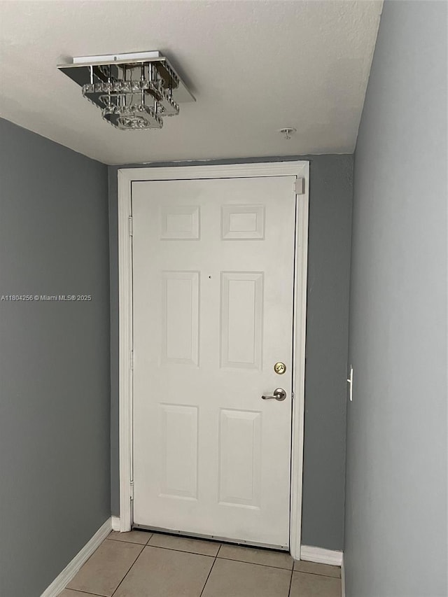 13780 NE 3rd Ct Unit 207, North Miami, FL 33161 - doorway to outside featuring light tile patterned floors and baseboards