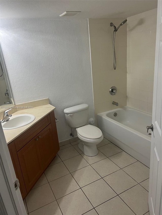 13780 NE 3rd Ct Unit 207, North Miami, FL 33161 - full bath with toilet, tile patterned floors, vanity,  shower combination, and a textured wall