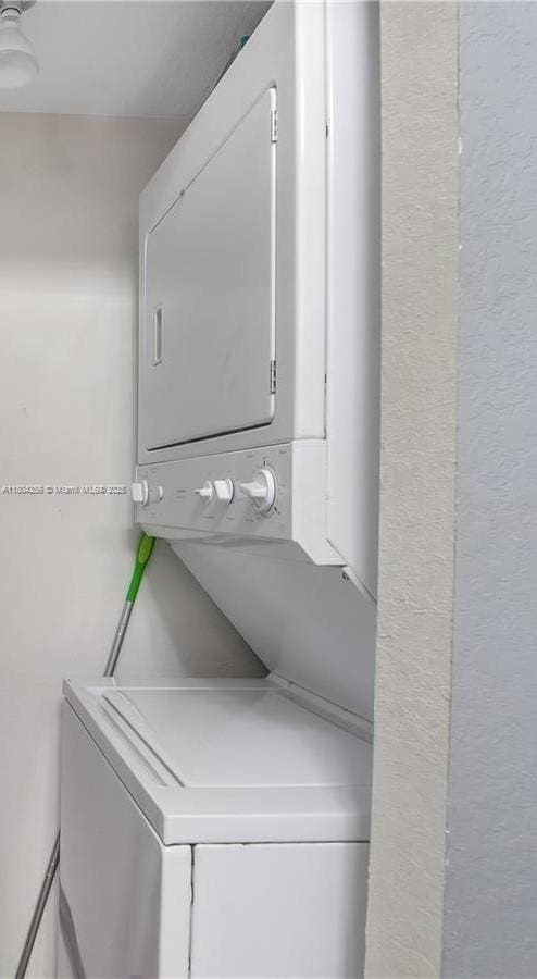 13780 NE 3rd Ct Unit 207, North Miami, FL 33161 - laundry room featuring stacked washing machine and dryer