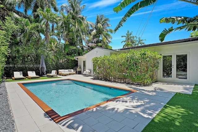 3020 Alton Rd, Miami Beach, FL 33140 - swimming pool with a patio, an outdoor living space, and french doors