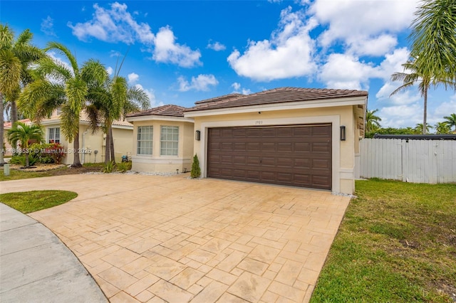 1903 SW 180th Ter, Miramar, FL 33029 - view of front facade with stucco siding, decorative driveway, a garage, and a tiled roof