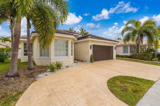 1903 SW 180th Ter, Miramar, FL 33029 - view of front of house featuring stucco siding, driveway, a garage, and a tile roof