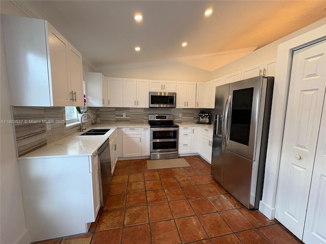 1903 SW 180th Ter, Miramar, FL 33029 - kitchen featuring stainless steel appliances, a sink, tasteful backsplash, white cabinets, and lofted ceiling