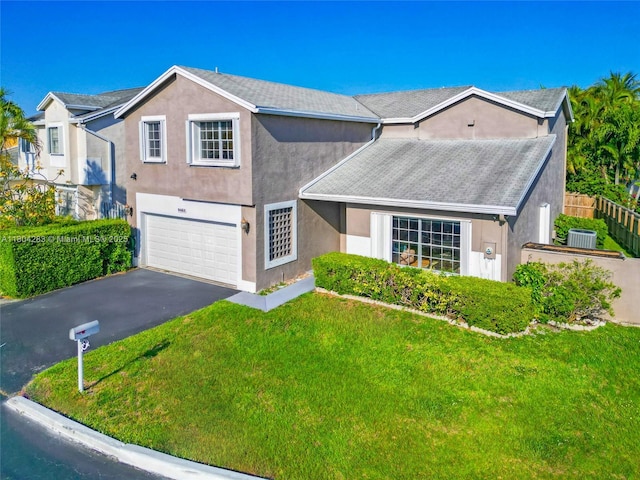 9465 SW 146th Ct, Miami, FL 33186 - view of front of house featuring stucco siding, asphalt driveway, and a garage