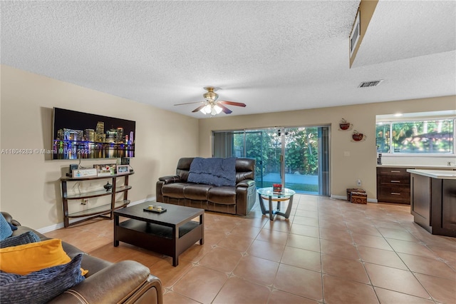9465 SW 146th Ct, Miami, FL 33186 - living room featuring plenty of natural light, ceiling fan, a textured ceiling, and light tile patterned flooring