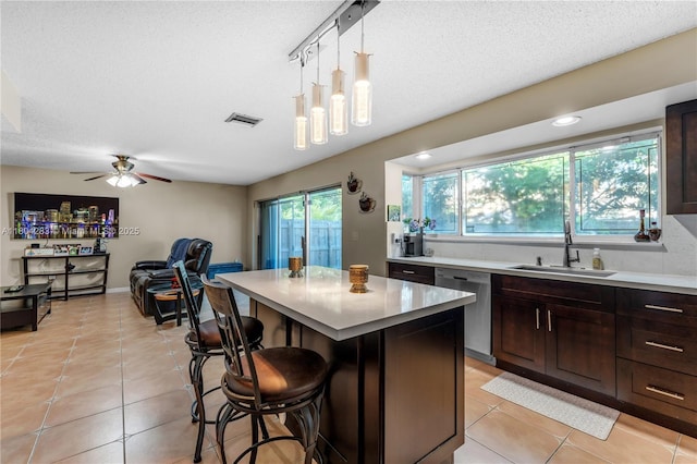 9465 SW 146th Ct, Miami, FL 33186 - kitchen featuring a sink, dishwasher, a kitchen breakfast bar, light countertops, and light tile patterned floors