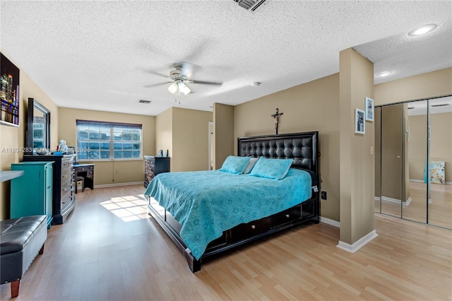 9465 SW 146th Ct, Miami, FL 33186 - bedroom featuring light wood-style flooring, a textured ceiling, baseboards, a ceiling fan, and a closet