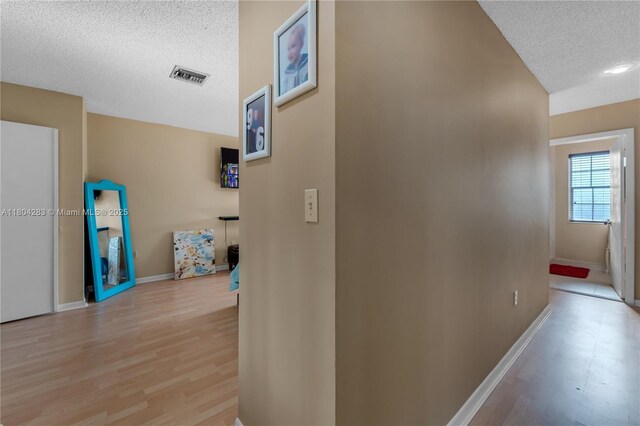 9465 SW 146th Ct, Miami, FL 33186 - corridor with a textured ceiling, baseboards, and light wood-style floors