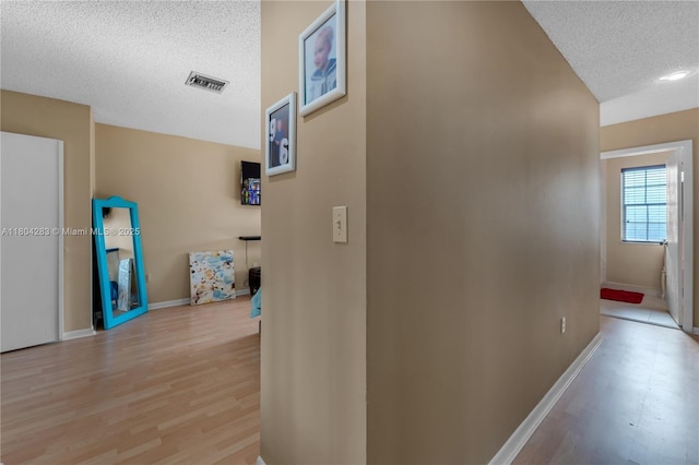 9465 SW 146th Ct, Miami, FL 33186 - corridor with a textured ceiling and light wood finished floors