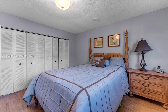 9465 SW 146th Ct, Miami, FL 33186 - bedroom with light wood-style floors, a closet, and a textured ceiling