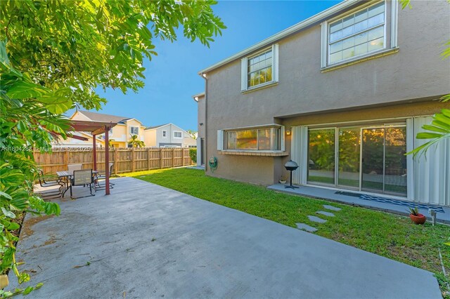 9465 SW 146th Ct, Miami, FL 33186 - back of house featuring a patio, stucco siding, outdoor dining space, and a residential view