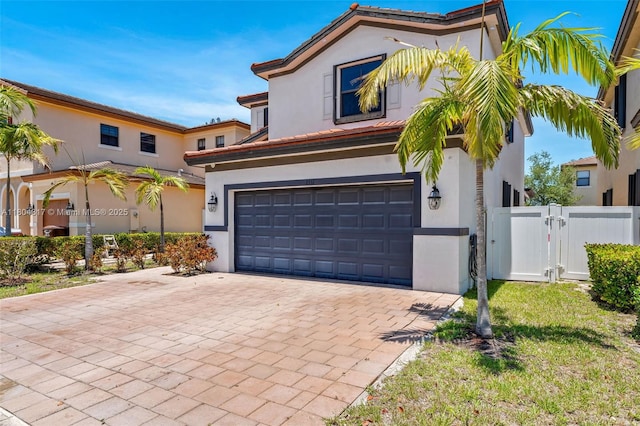 3531 W 104th Ter, Hialeah, FL 33018 - mediterranean / spanish-style home featuring an attached garage, stucco siding, a gate, and decorative driveway