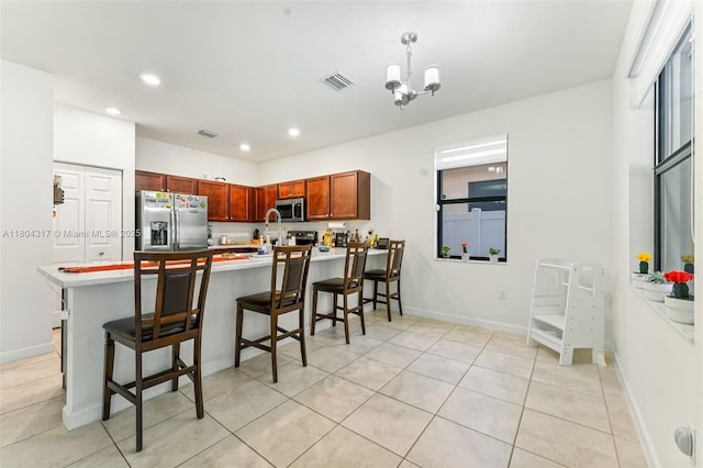 3531 W 104th Ter, Hialeah, FL 33018 - kitchen featuring appliances with stainless steel finishes, a peninsula, a breakfast bar area, light countertops, and recessed lighting