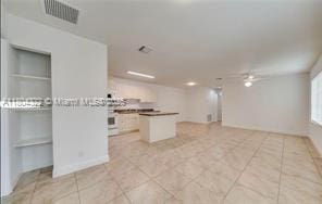 6035 SW 40th Ct, Miramar, FL 33023 - kitchen with open floor plan, light tile patterned floors, a center island, and a ceiling fan