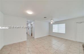 6035 SW 40th Ct, Miramar, FL 33023 - unfurnished room with a ceiling fan, light tile patterned floors, and baseboards