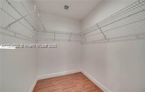 6035 SW 40th Ct, Miramar, FL 33023 - spacious closet featuring wood finished floors