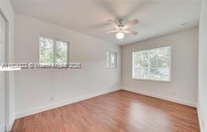 6035 SW 40th Ct, Miramar, FL 33023 - empty room with baseboards, ceiling fan, and wood finished floors