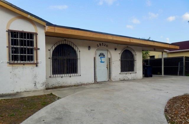 28520 SW 142nd Ave, Homestead, FL 33033 - entrance to property featuring stucco siding and fence